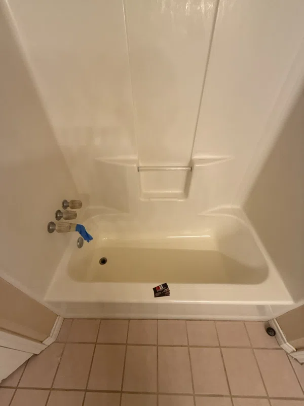 One-piece tub and shower surround with molded shelves.