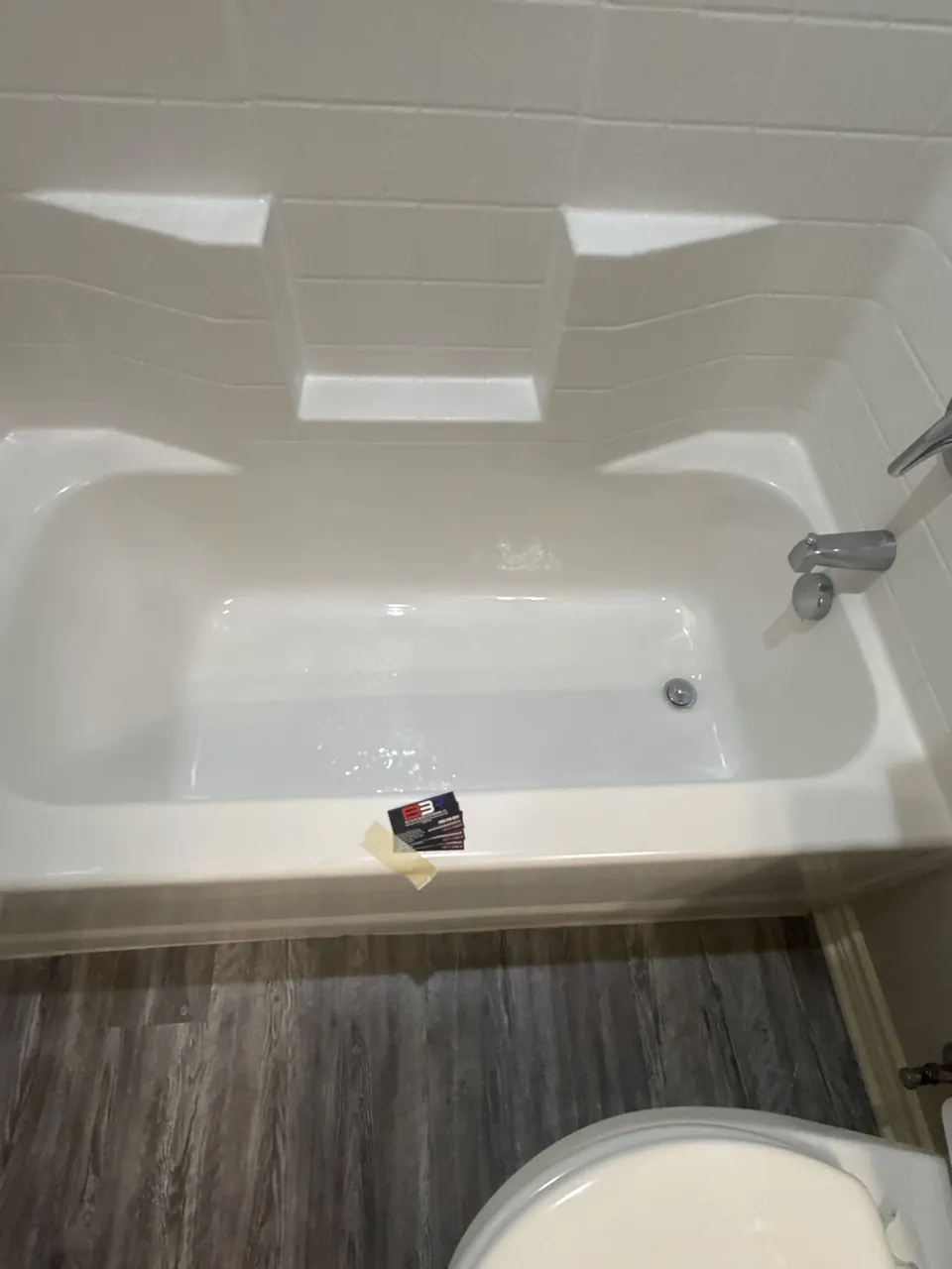 White fiberglass bathtub and surround from a bottom rebuild project in Tyler, Texas.