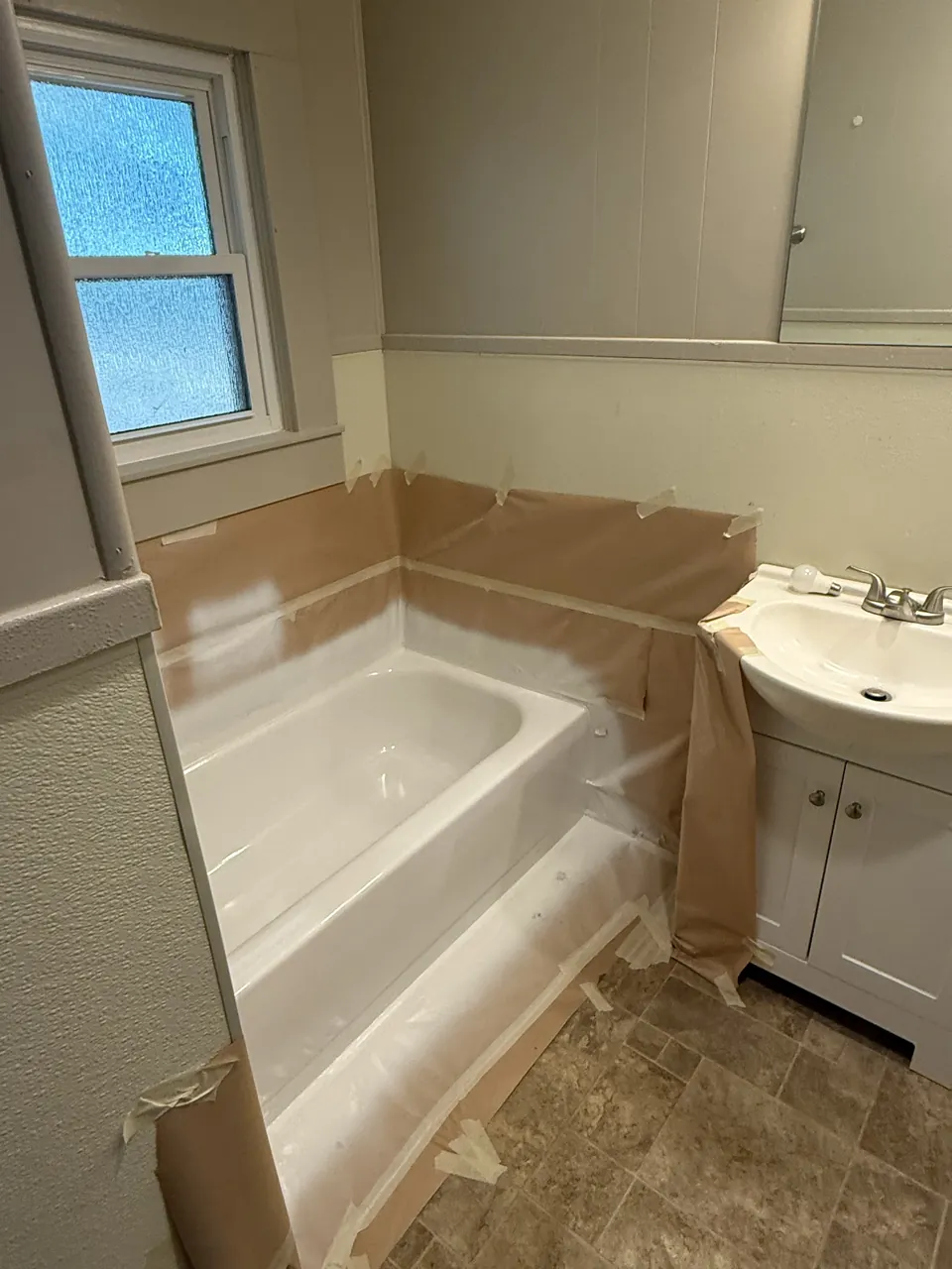 Bathtub surrounded by masking paper and protective film