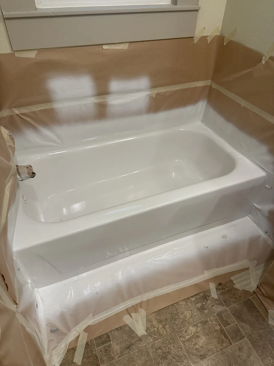 Protected bathtub work area with masking still in place