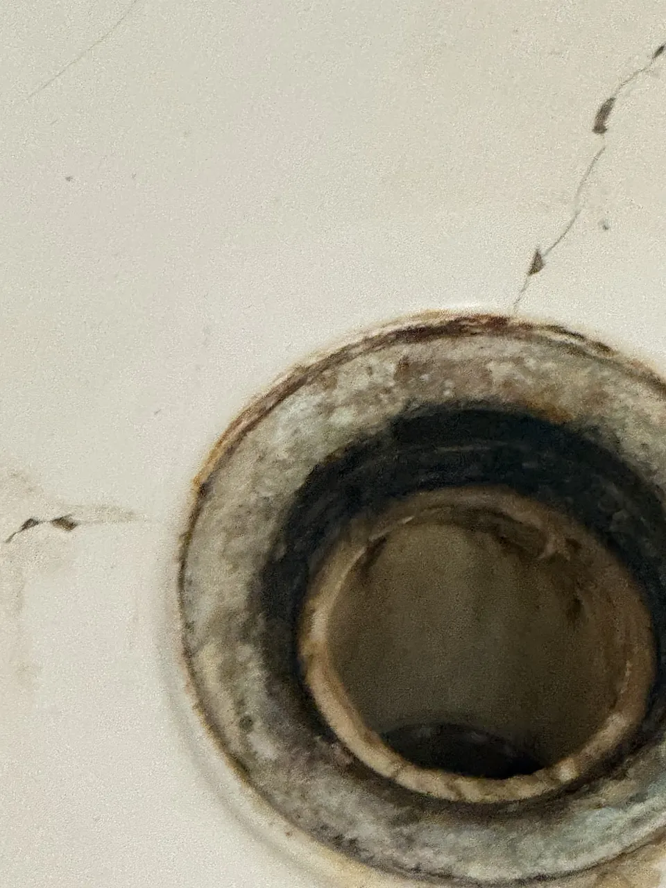Close view of damage around shower drain