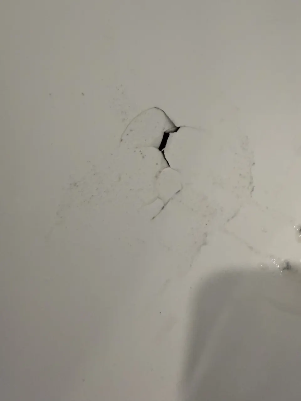 Small broken area and cracking in fiberglass surface